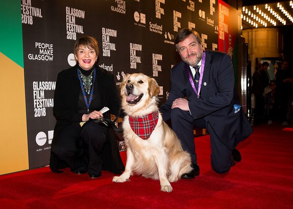 Festival directors Allison Gardner and Allan Hunter with George the Ambassadog on the Isle Of Dogs red carpet in 2018