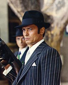 Alain Delon in one of his iconic gangster poses in Borsalino