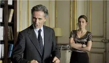 Thierry Lhermitte as the French Minister with Julie Gayet as Valerie Dumontheil: "The things he picks from the books are really bizarre but it's part of his universe."